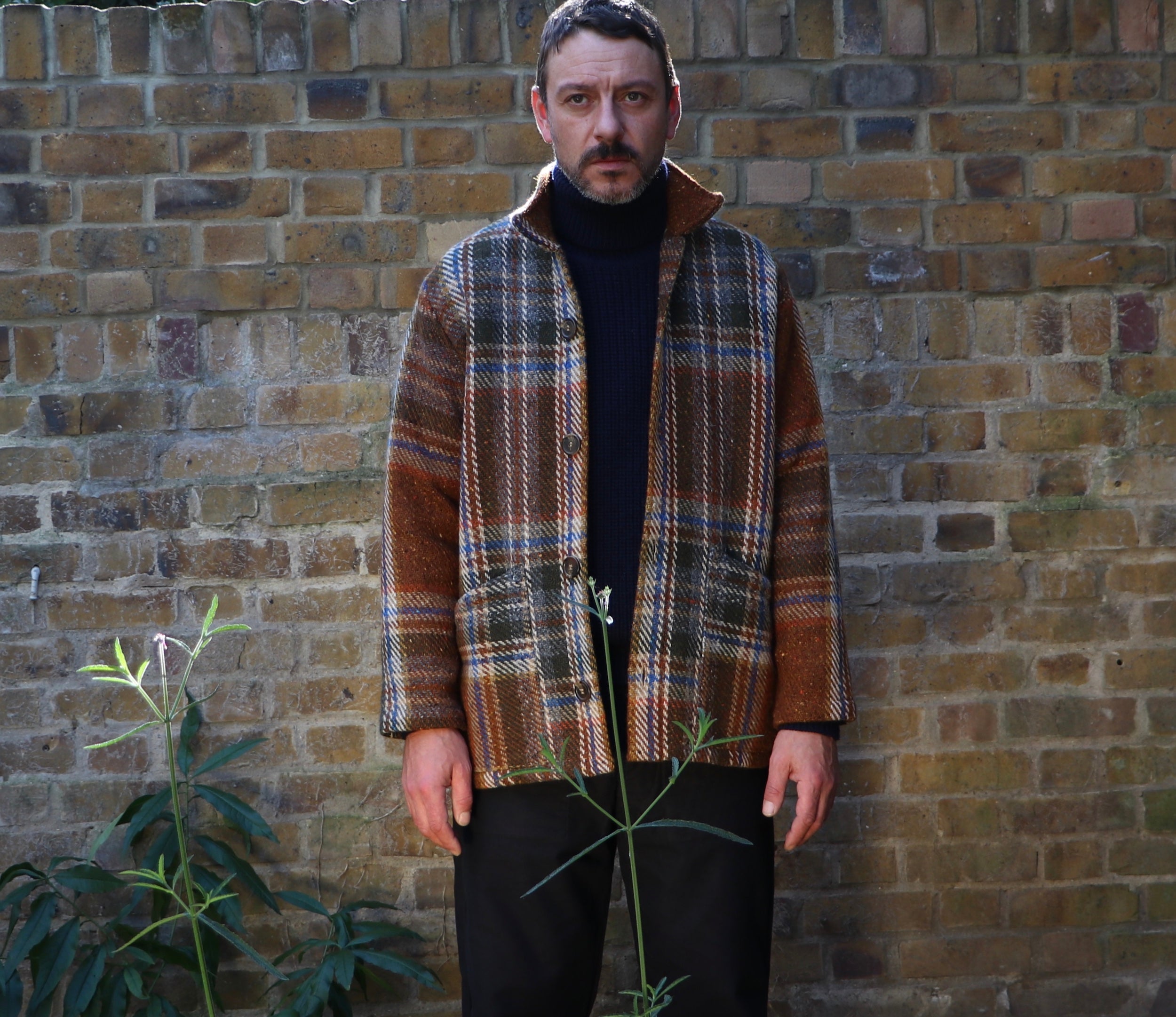 Man wears Carrier Company Celtic Wool Jacket in Russett