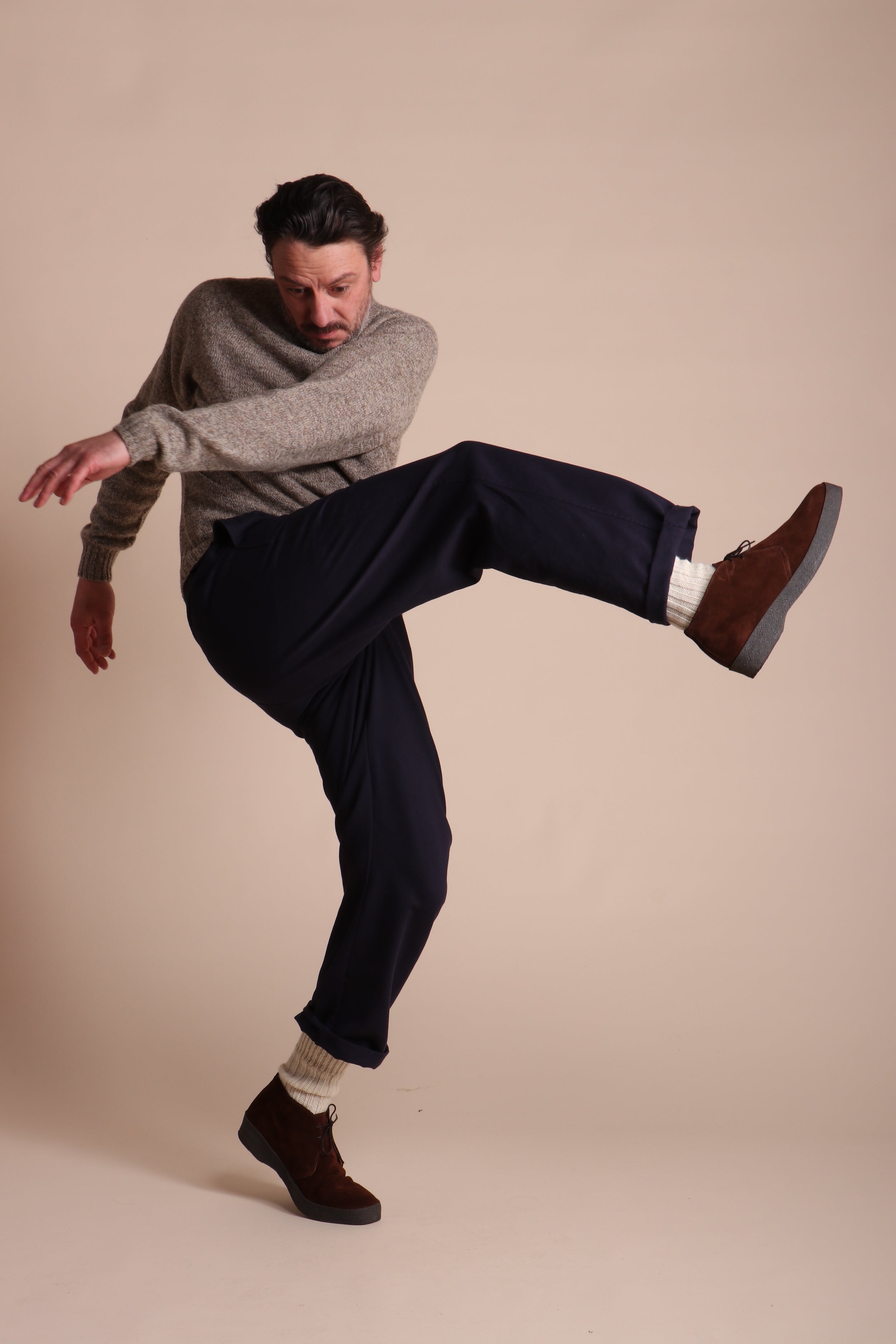 Man wears Carrier Company Classic Trouser in Navy Drill with Shetland Lambswool Jumper