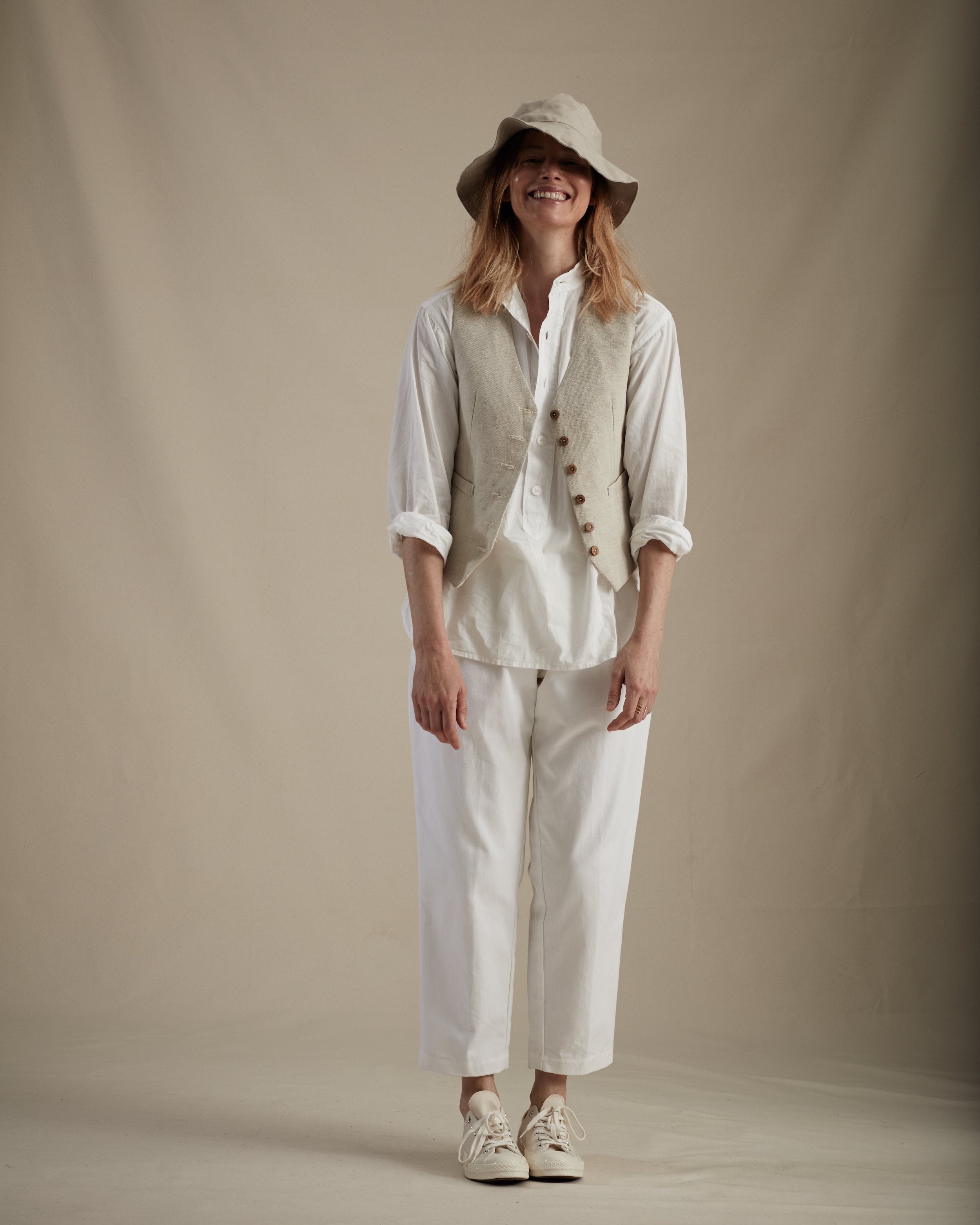 Woman wears Carrier Company Lightweight Collarless Shirt with Cropped Trouser, Lightweight Waistcoat and Cotton Sun Hat