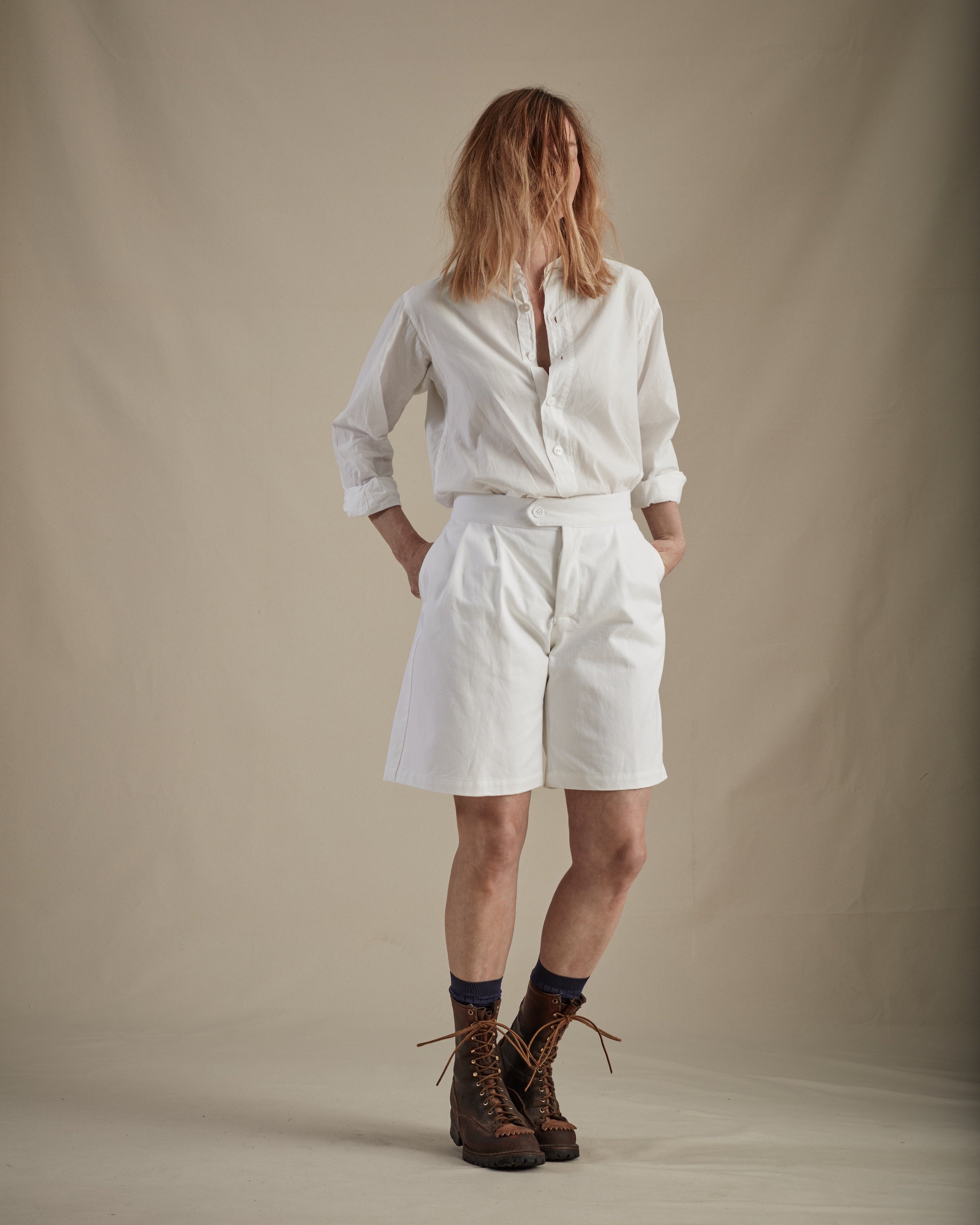 Woman wears Carrier Company Lightweight Collarless Shirt with Ladies Shorts in White