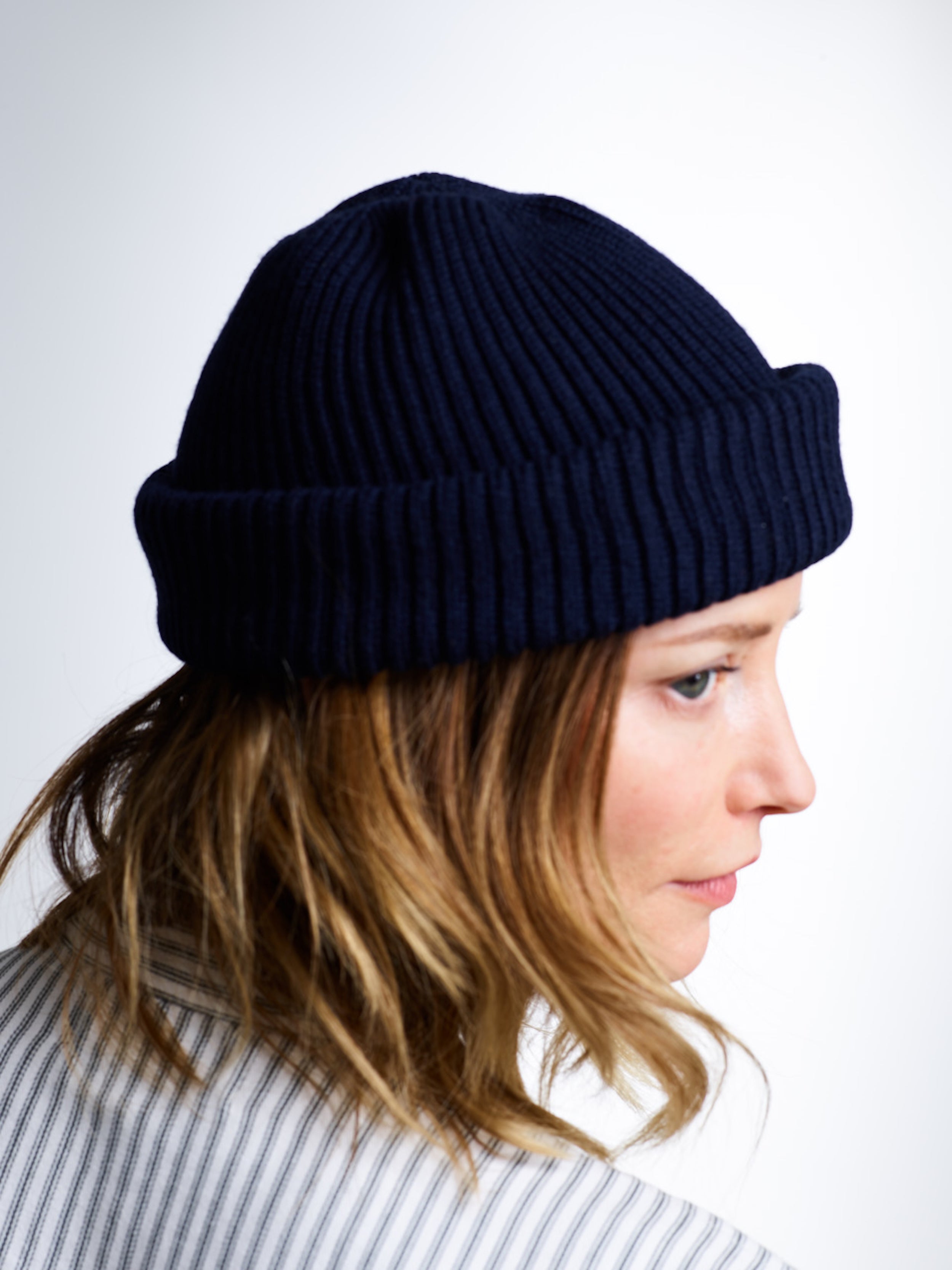 Woman wears Carrier Company Wool Hat in Navy and Collarless Work Shirt