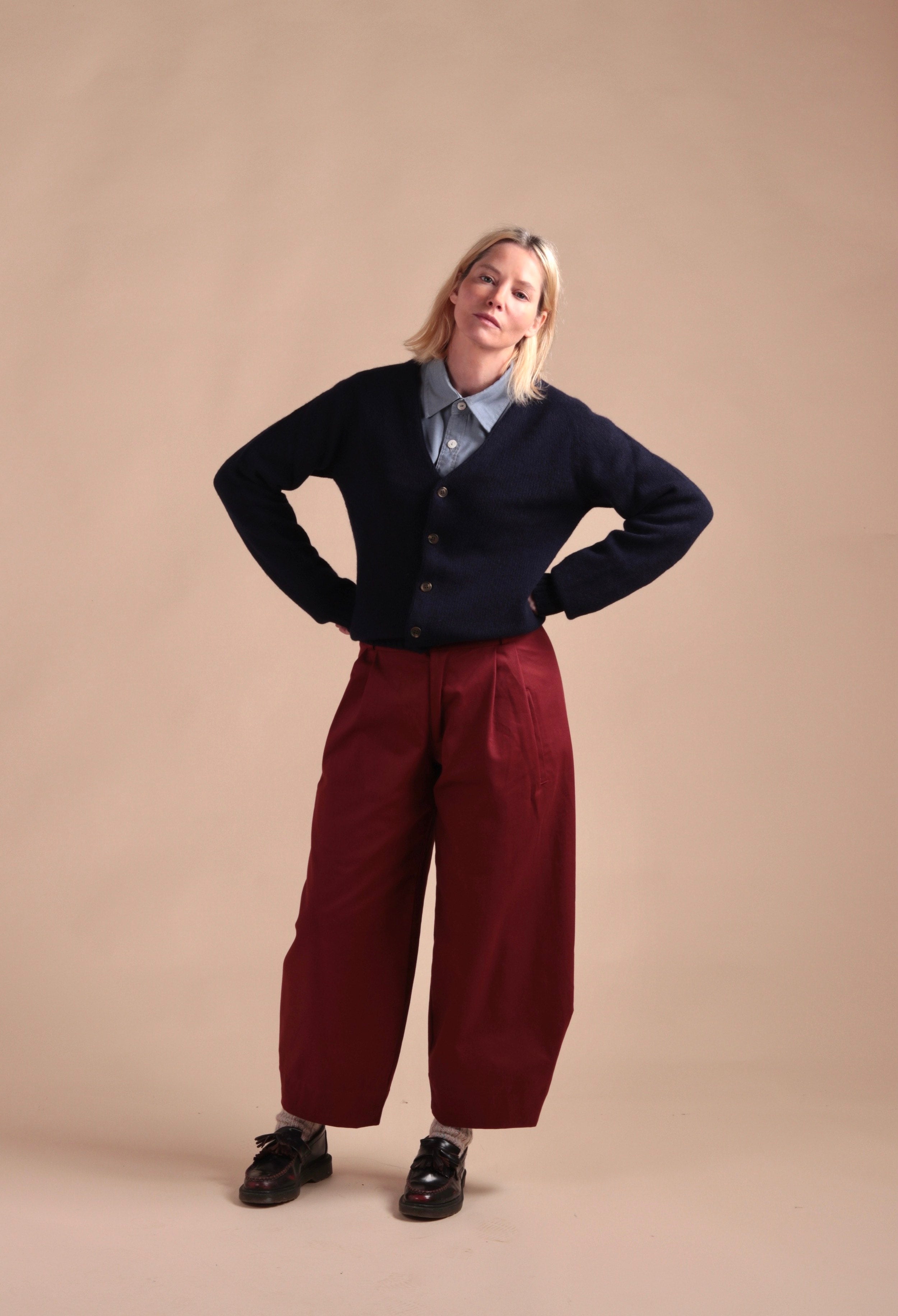 Sienna wears Carrier Company Dutch Trouser in Breton red with Navy Cardigan