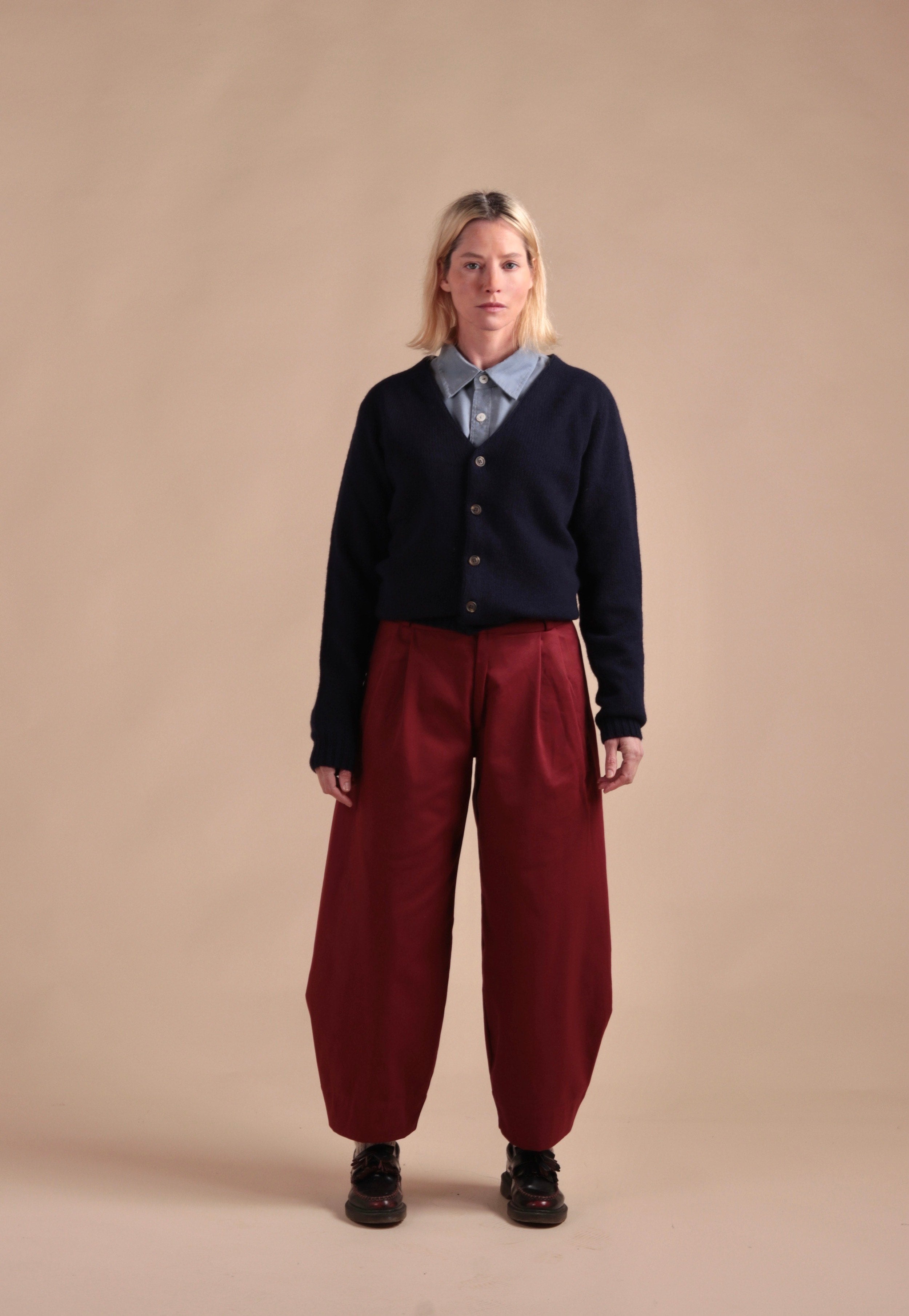 Sienna wears Carrier Company Dutch Trouser in Breton red with and Navy Cardigan
