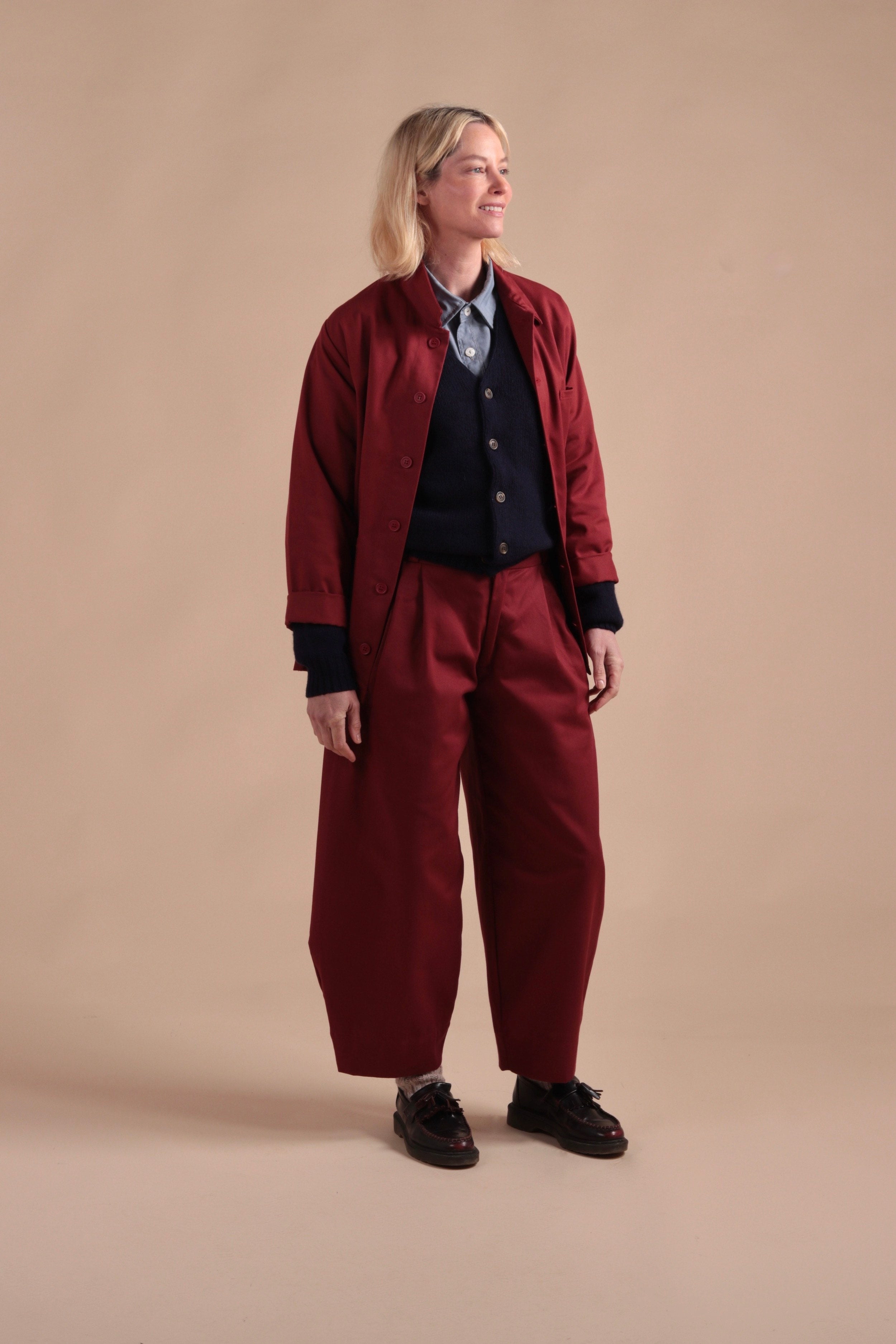 Sienna wears Carrier Company Dutch Trouser in Breton red with Norfolk Work Jacket in Breton Red and Navy Cardigan