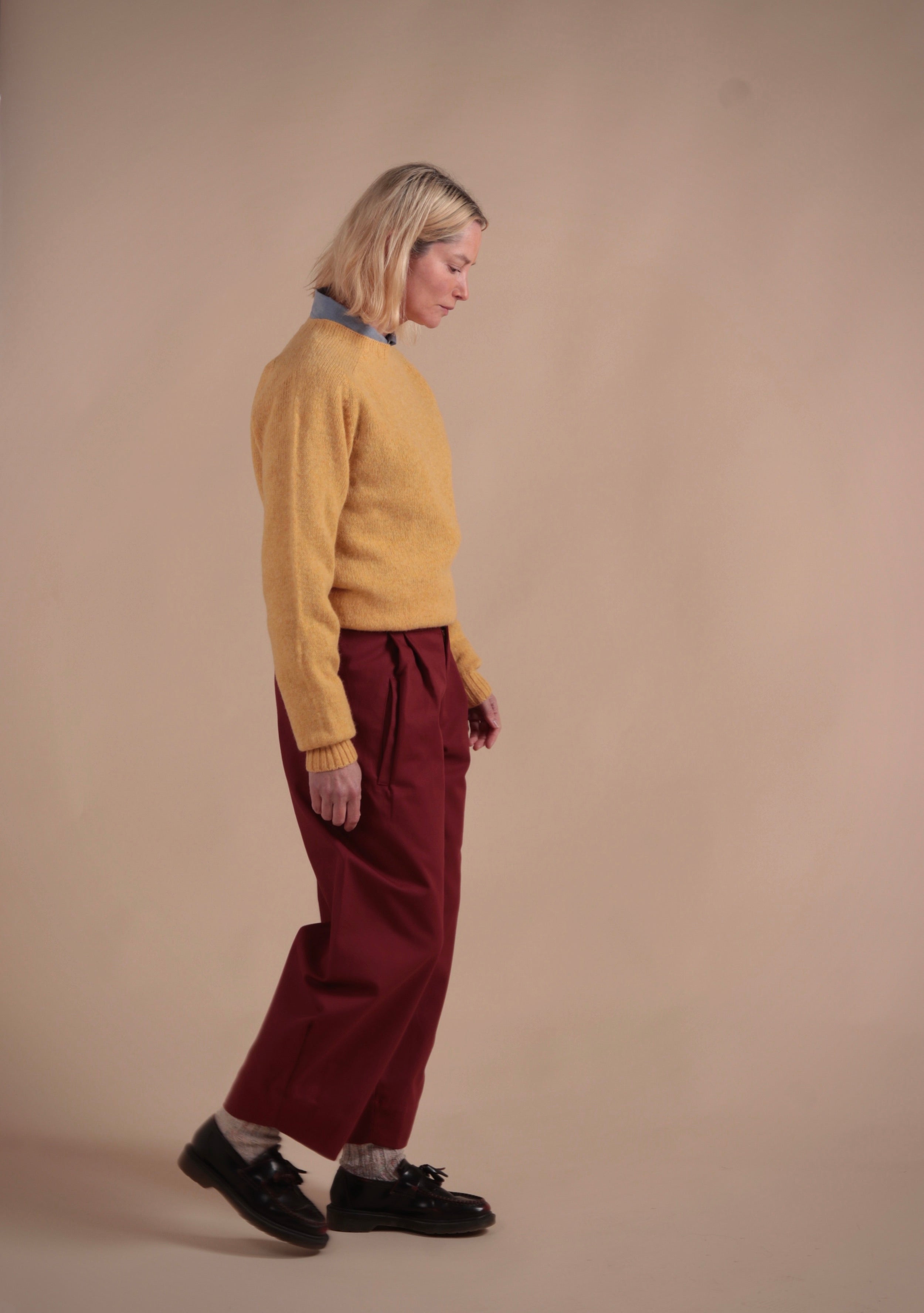 Woman wearing Carrier Company Shetland Lambswool Jumper in Chamomile with Breton Red Dutch Trouser in Cotton Drill