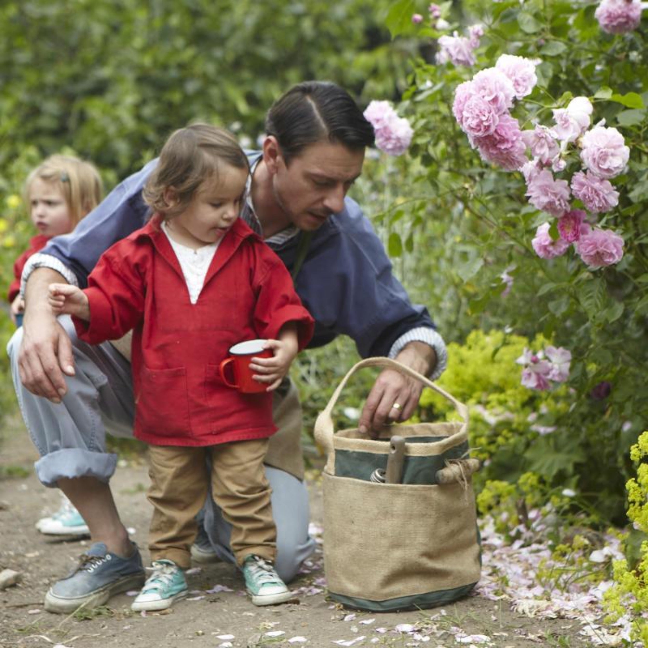 Gardener using Carrier Company Gardener's Pail in Jute and Olive Canvas