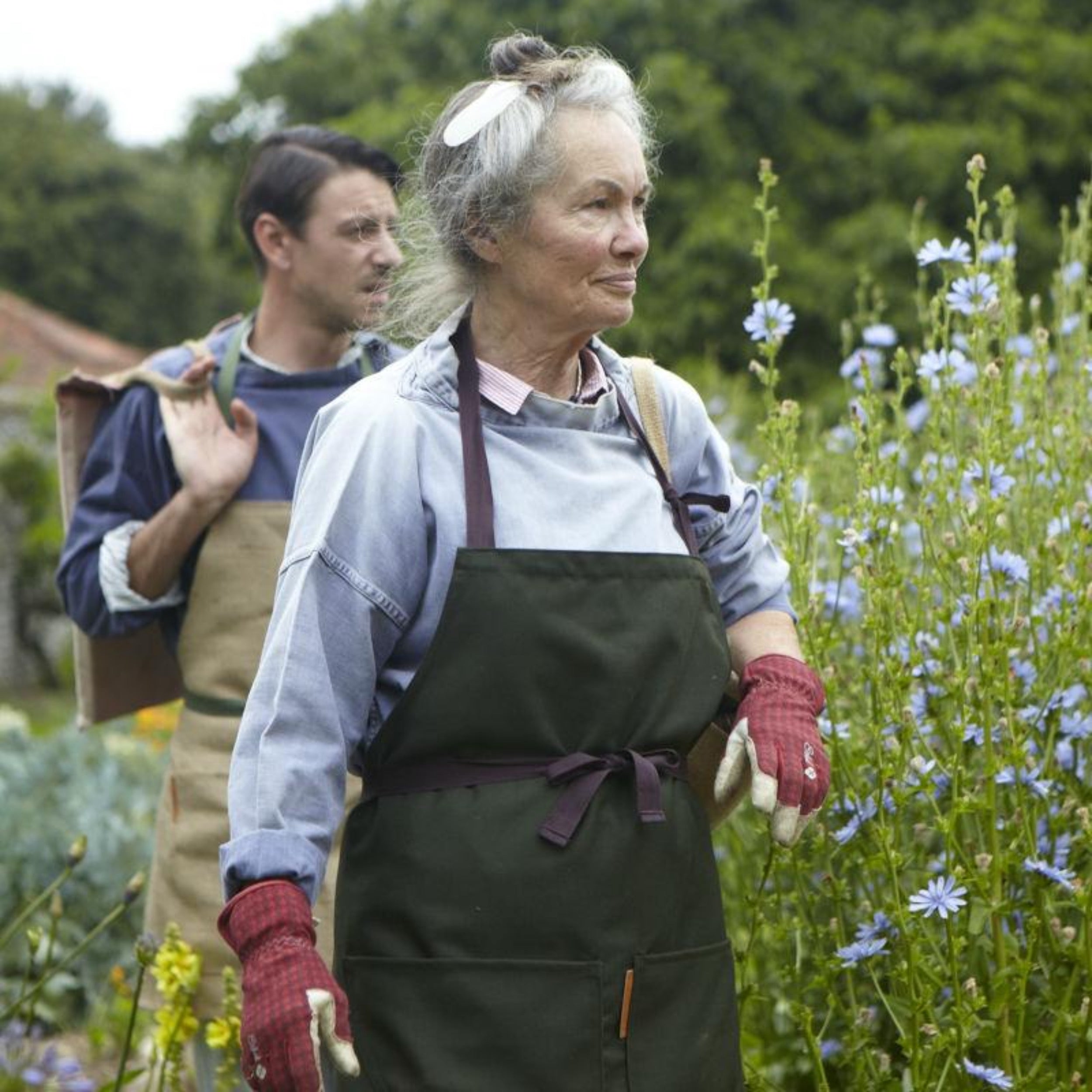 Woman wears Carrier company Long Apron in Olive