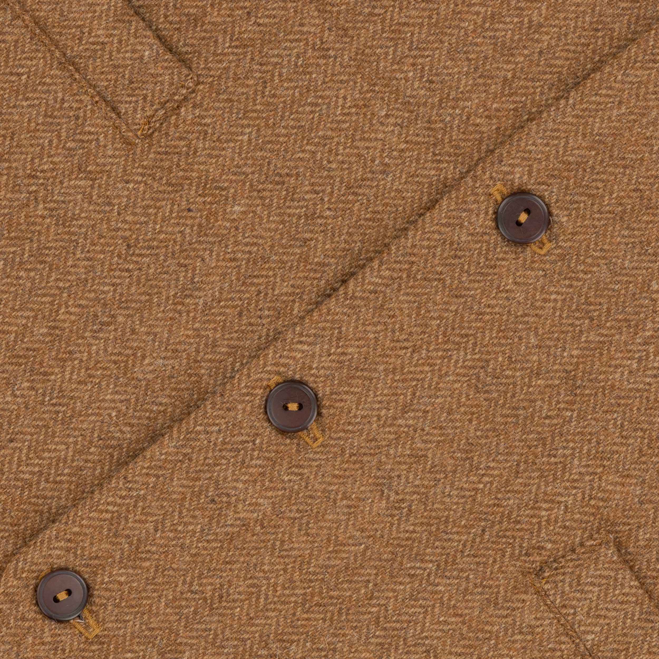 Close up of the button detail on the Carrier Company Men's Wool Waistcoat in Ginger Herringbone