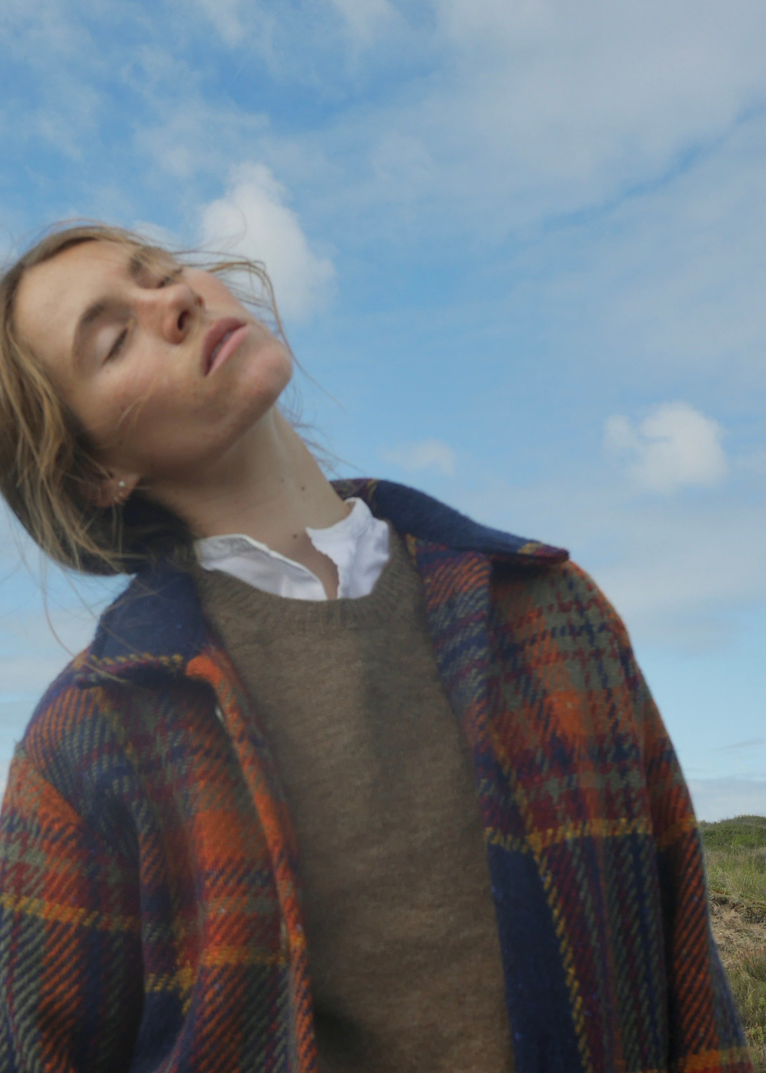 Woman wears Carrier Company Celtic Wool Jacket in Navy and Rust with Shetland Lambswool Jumper and Dutch Trouser in Corduroy